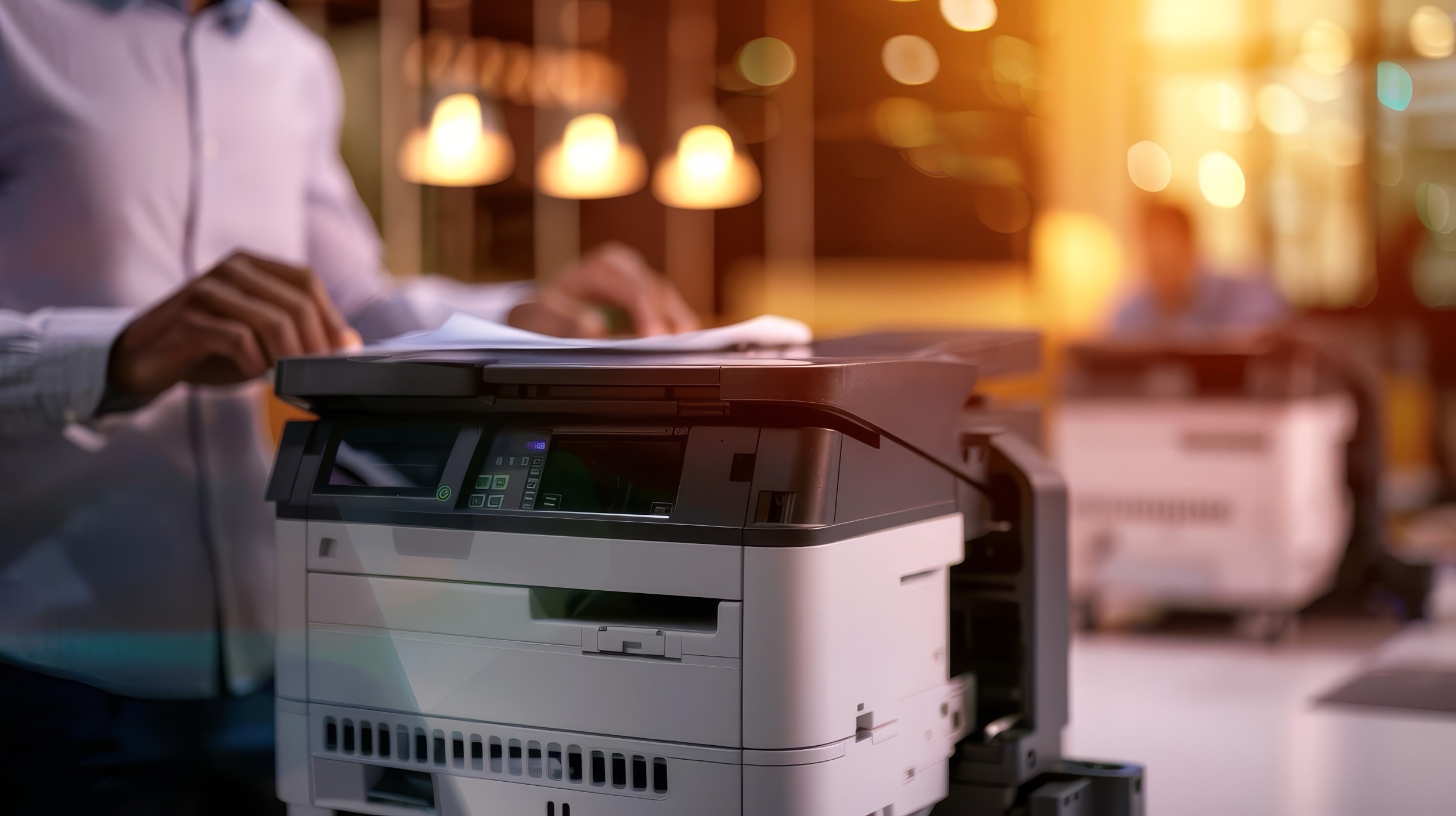 Businessman using a multifunction printer in an office setting.